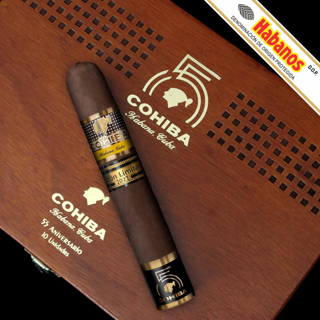 A single Cohiba 55 Aniversario Limited Edition 2021 cigar placed diagonally across an engraved wooden box. The cigar has a dark brown wrapper with a gold-and-black band, and the box is brown wood with gold-and-black printed branding, including a large '55' and 'Cohiba'.