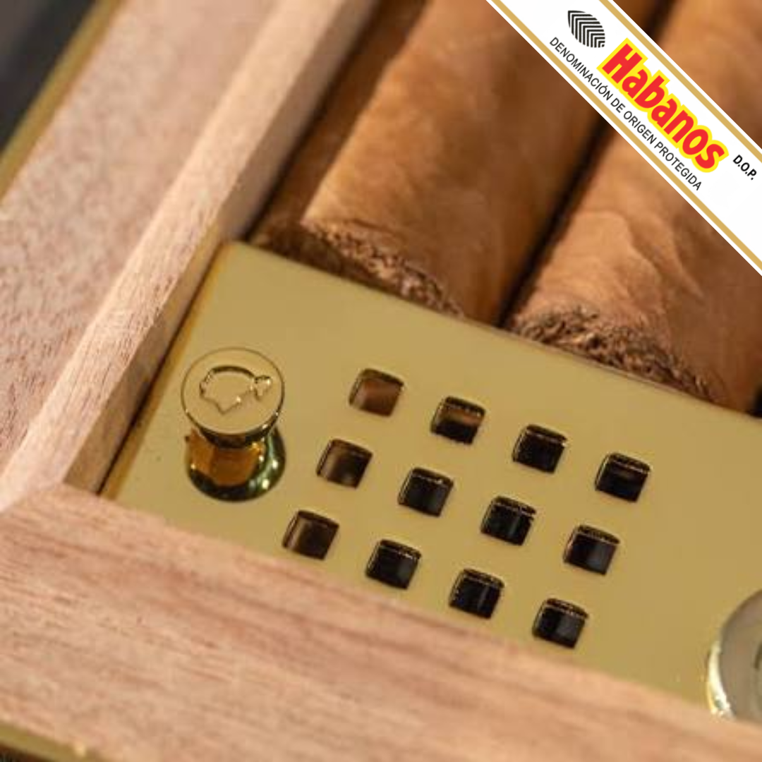 Close-up of a Cohiba Selección 50th Anniversary Travel Humidor with a gold metal tray, visible cigars, and a diagonal Habanos brand overlay in the top right corner.